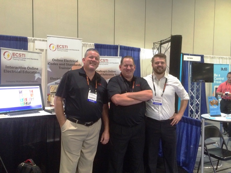 Stallcup guys and josh standing in front of their booth